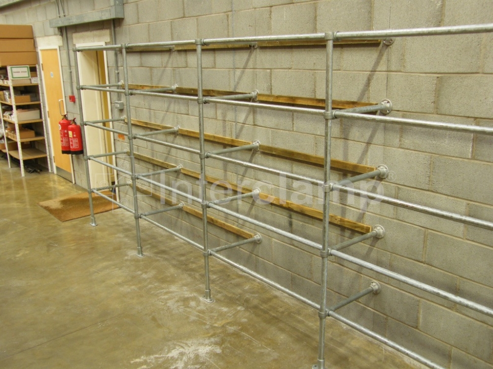 Interclamp tube clamp fittings used to build robust shelving units in a warehouse, designed to meet specific storage requirements and efficiently organize a wide range of items.
